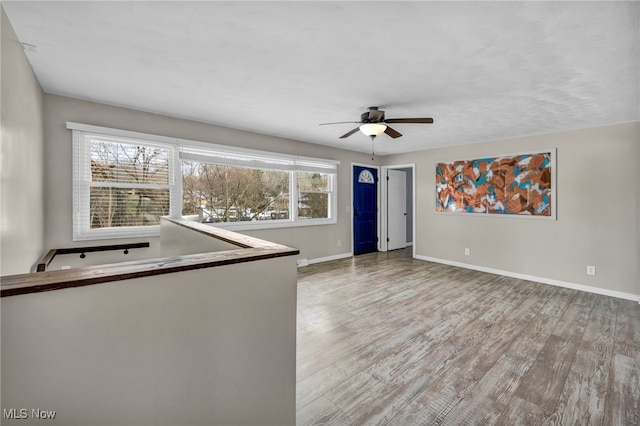 empty room featuring hardwood / wood-style flooring and ceiling fan