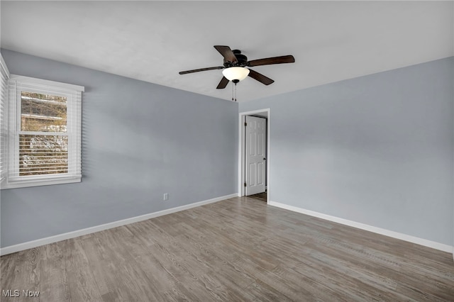 spare room with ceiling fan and hardwood / wood-style flooring