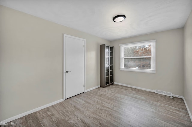 spare room featuring light hardwood / wood-style flooring