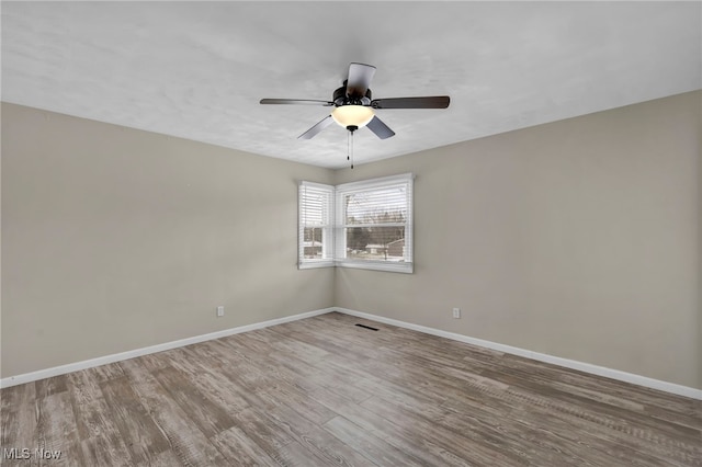 spare room featuring hardwood / wood-style flooring and ceiling fan