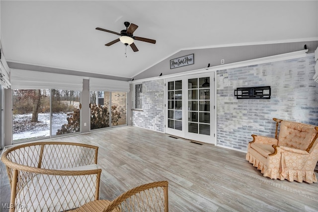 sunroom / solarium featuring ceiling fan and lofted ceiling