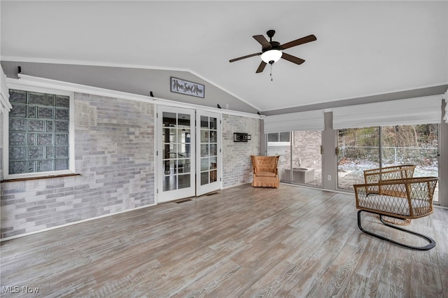 unfurnished room featuring hardwood / wood-style flooring, ceiling fan, and lofted ceiling