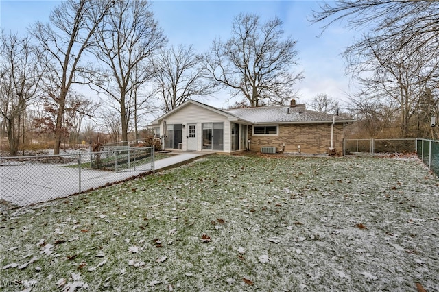 rear view of house with a yard and central AC unit