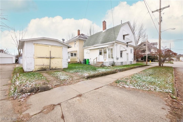 rear view of house featuring a storage unit and a yard