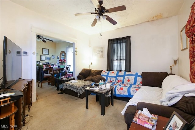 living room featuring light carpet and ceiling fan