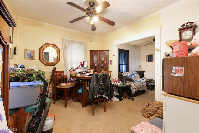 office area with a textured ceiling, light colored carpet, and ceiling fan