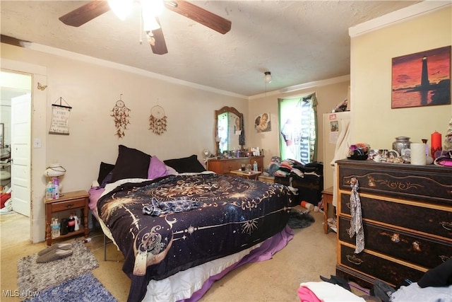 bedroom with carpet flooring, ceiling fan, and crown molding