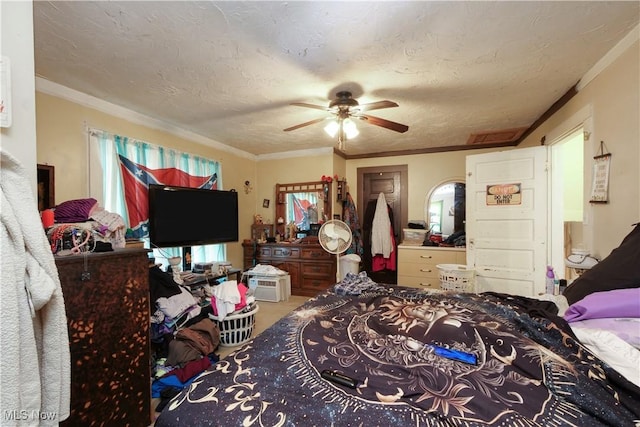 bedroom featuring ceiling fan, a textured ceiling, and multiple windows