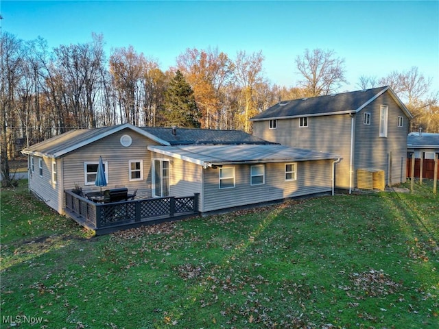 rear view of house with a yard