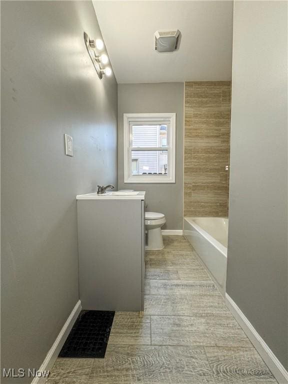 bathroom featuring hardwood / wood-style floors, vanity, and toilet