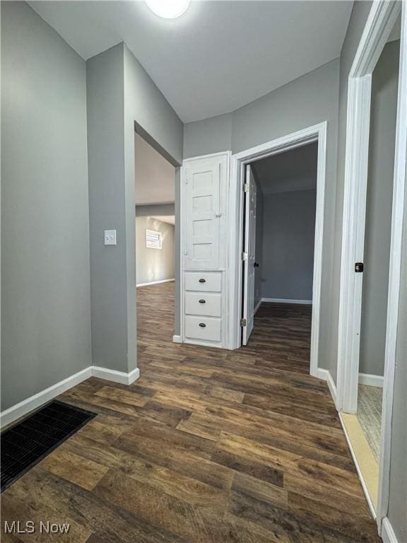 corridor featuring dark hardwood / wood-style flooring