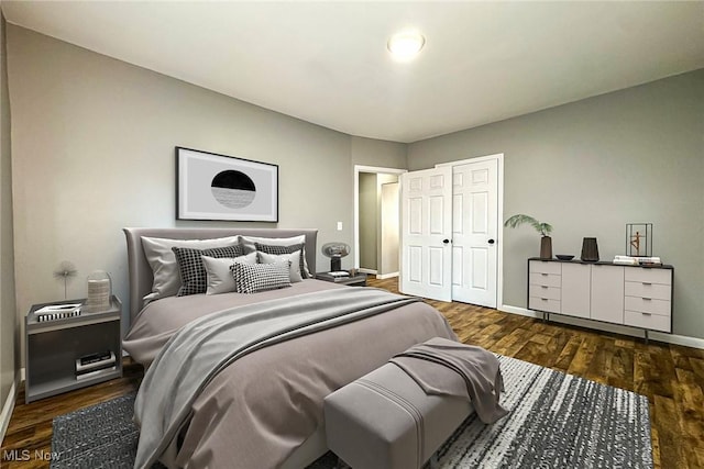 bedroom with dark hardwood / wood-style flooring