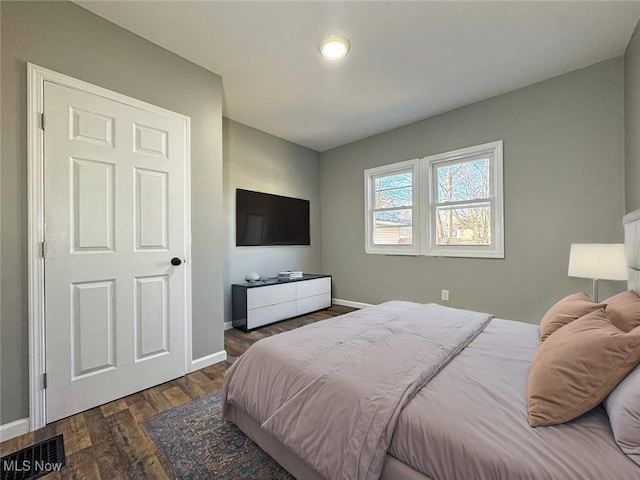 bedroom featuring dark hardwood / wood-style flooring