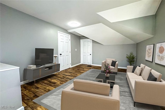 living room with dark hardwood / wood-style floors and lofted ceiling