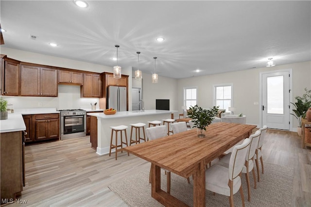 dining area with light hardwood / wood-style flooring and sink