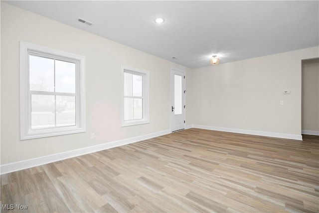 spare room featuring light wood-type flooring