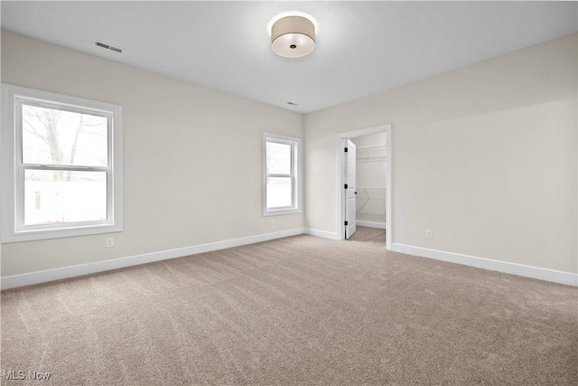 spare room featuring carpet floors and a healthy amount of sunlight