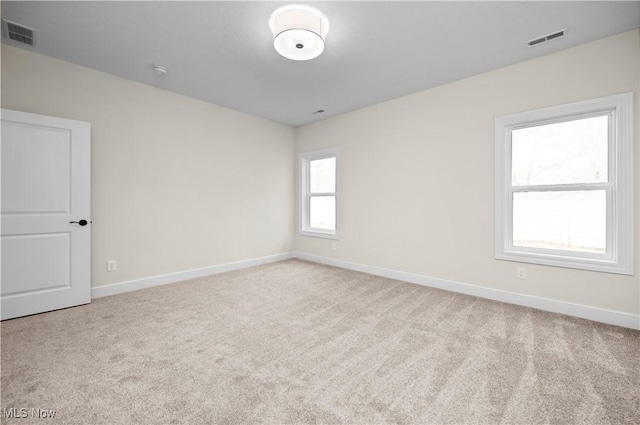 empty room featuring light colored carpet