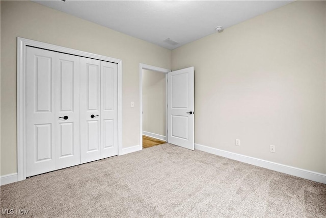 unfurnished bedroom featuring a closet and carpet floors