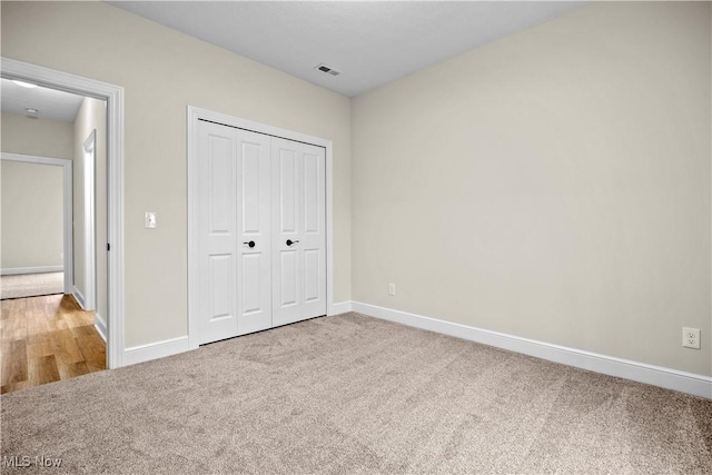 unfurnished bedroom featuring carpet floors and a closet