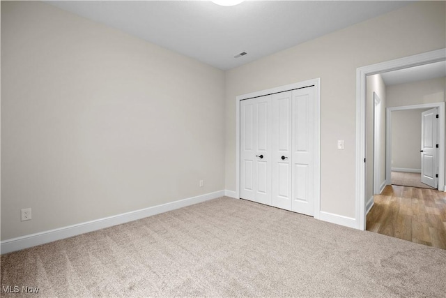 unfurnished bedroom featuring carpet floors and a closet