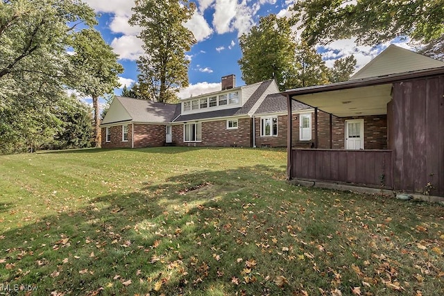 rear view of property with a yard