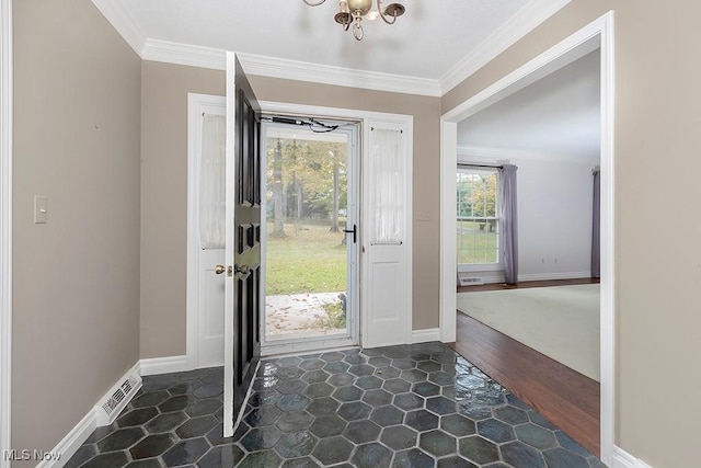 entrance foyer with dark hardwood / wood-style flooring, an inviting chandelier, and ornamental molding