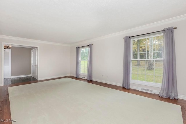 empty room featuring dark hardwood / wood-style floors and crown molding