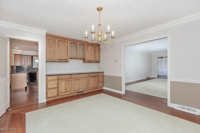 kitchen featuring tasteful backsplash, dark hardwood / wood-style floors, crown molding, a chandelier, and pendant lighting