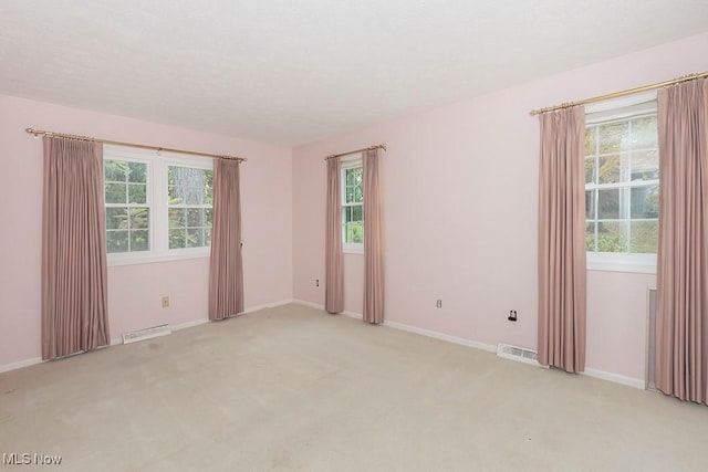 empty room with light colored carpet