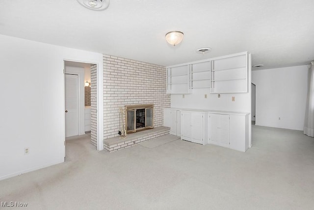 unfurnished living room featuring a brick fireplace