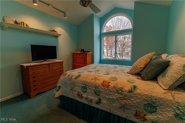 carpeted bedroom featuring ceiling fan, track lighting, and vaulted ceiling