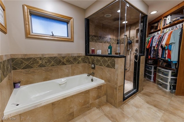 bathroom featuring shower with separate bathtub