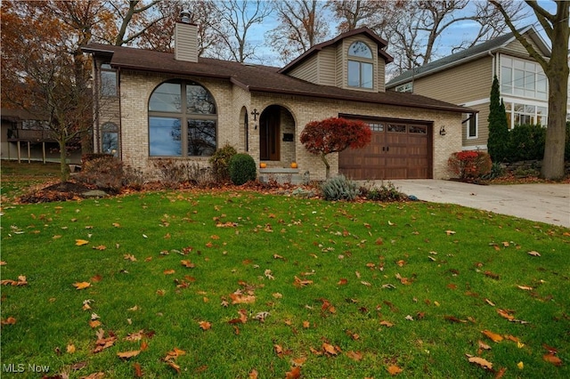 view of front of home featuring a garage and a front lawn