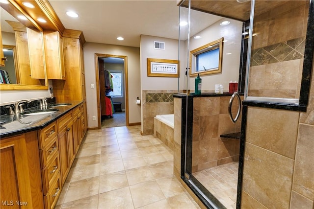 bathroom featuring separate shower and tub, tile patterned flooring, and vanity