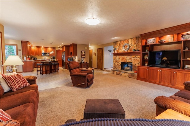 carpeted living room with a fireplace and a textured ceiling