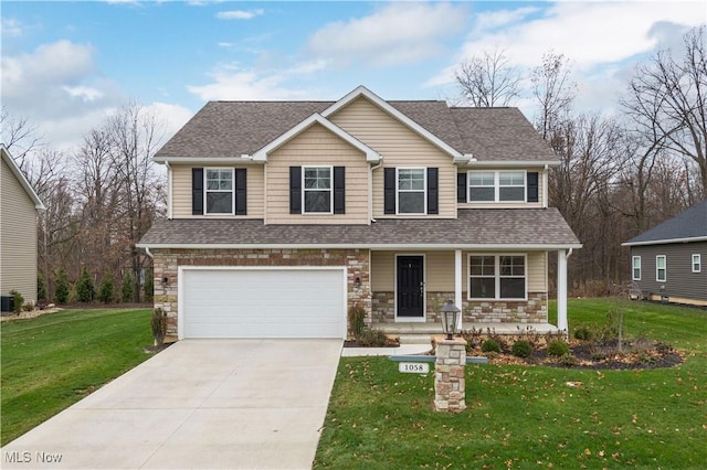 view of front of property with cooling unit, a garage, and a front lawn