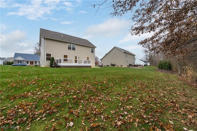 rear view of house featuring a lawn