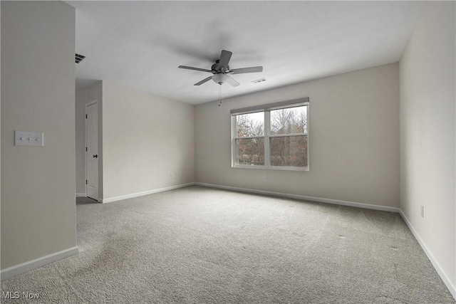 carpeted spare room with ceiling fan