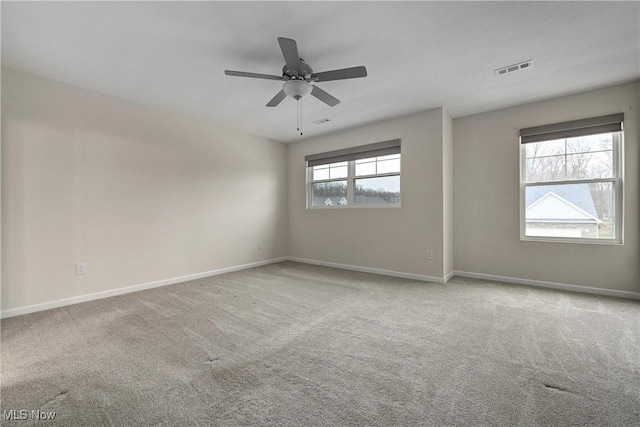 carpeted spare room featuring ceiling fan