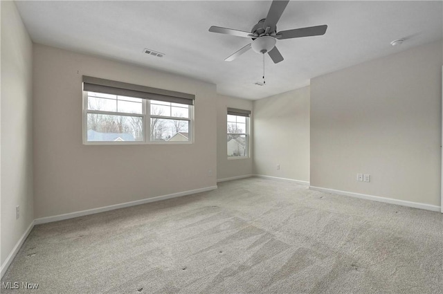 unfurnished room with light colored carpet and ceiling fan