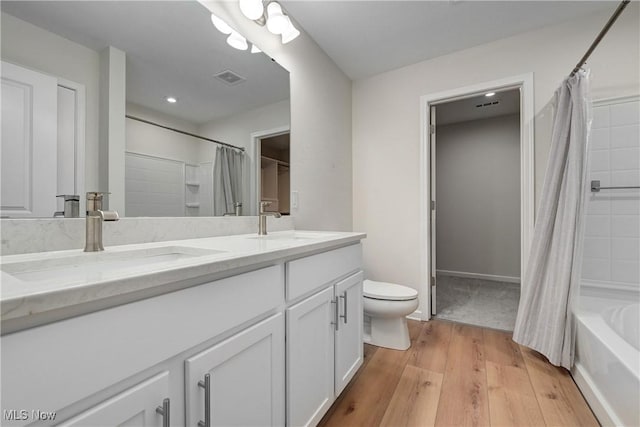 full bathroom featuring shower / bath combination with curtain, vanity, wood-type flooring, and toilet