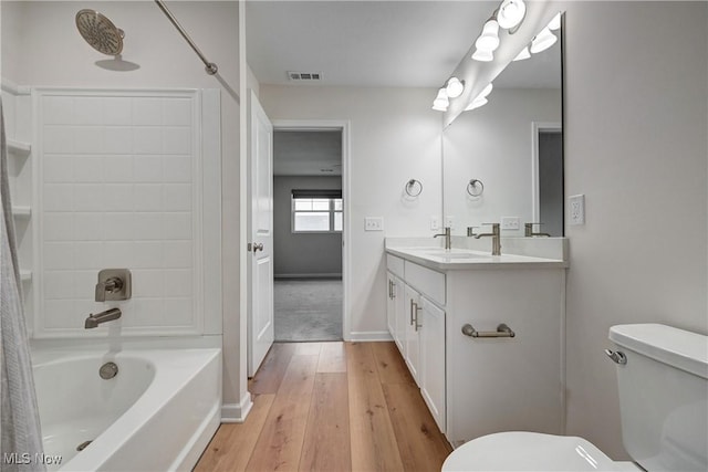 full bathroom with wood-type flooring, vanity, toilet, and shower / washtub combination