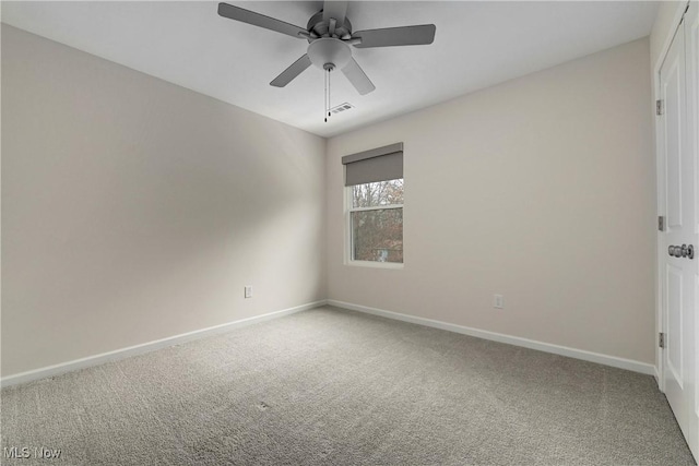 carpeted spare room featuring ceiling fan