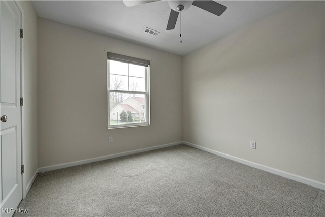 carpeted empty room featuring ceiling fan