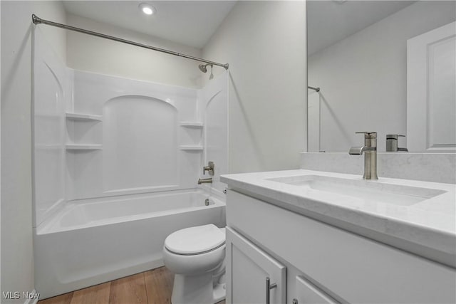 full bathroom with hardwood / wood-style floors, vanity, toilet, and bathing tub / shower combination