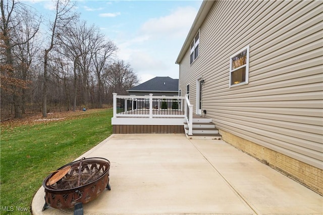 view of patio featuring a wooden deck and an outdoor fire pit