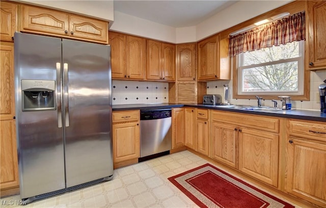 kitchen featuring appliances with stainless steel finishes, backsplash, and sink