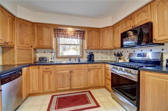 kitchen with stainless steel appliances, tasteful backsplash, and sink