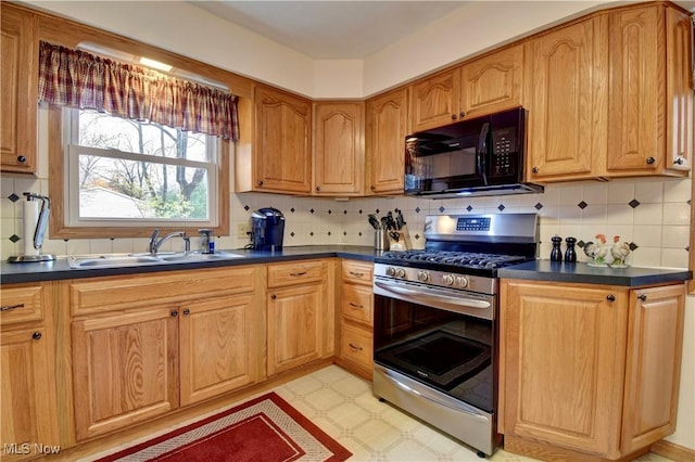 kitchen with backsplash, sink, and stainless steel range with gas stovetop